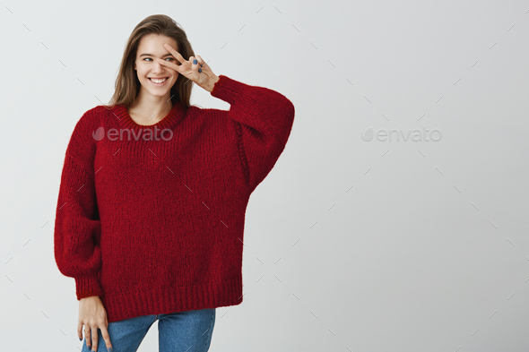 Say hi to new opportunities ahead. Studio shot of good-looking happy woman in trendy loose sweater