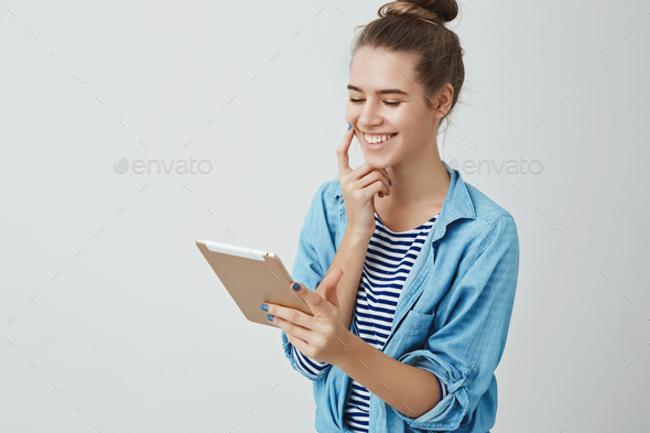 Lucky cute girl winning tickets cinema online lottery looking pleased satisfied digital tablet