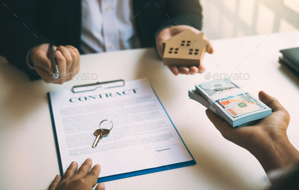 Insurance brokers are pointing to insurance contract signing and are explaining - Stock Photo - Images