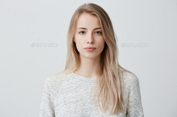 Confident good-looking beautiful woman with blonde dyed hair with healthy pure skin dressed in