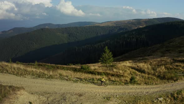 Drone Rocky Road Biking Man Enjoying Time Against Green Woods Pikes Background alt
