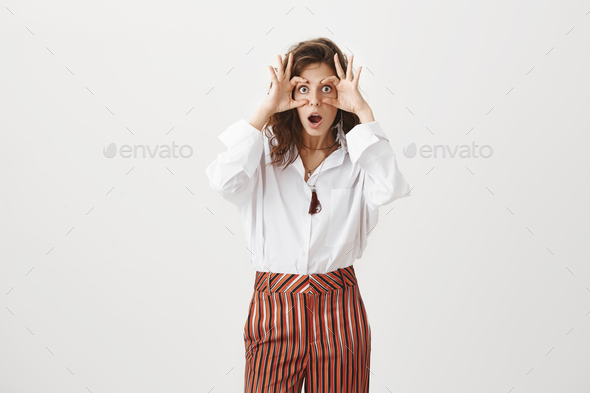 Girl opens eyes to see truth, making shocking revelation. Funny attractive woman in stylish blouse