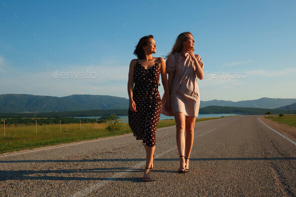 Two Girls Walking Down The Road Holding Hands Stock Photo By Aleksandra Iarosh