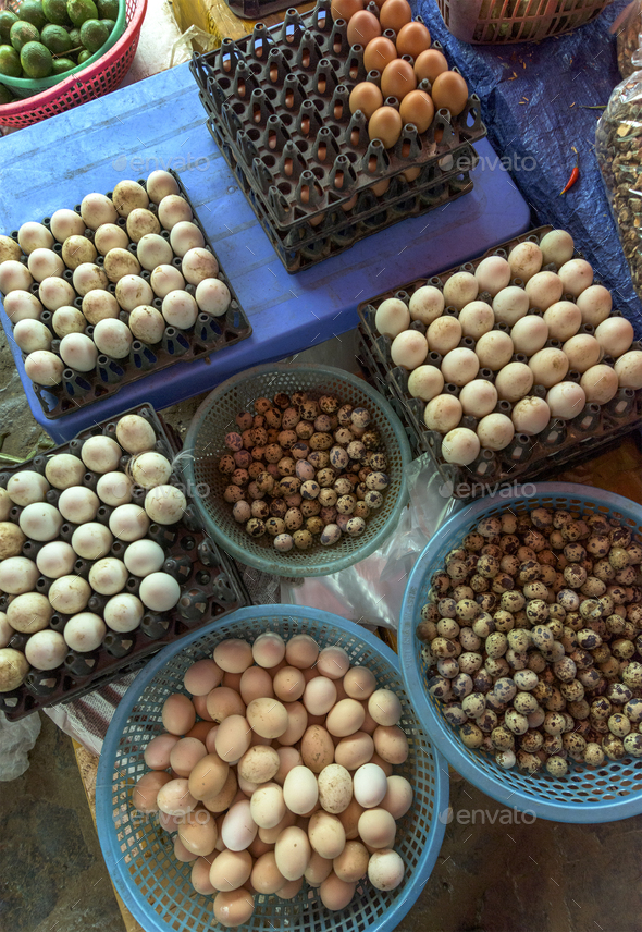 Top view on a assortment of loose eggs on a market, short circui