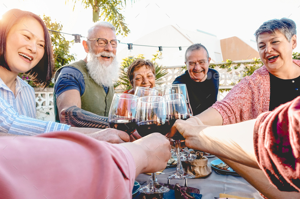 Happy Senior Friends Toasting With Red, Patio Wine Glasses