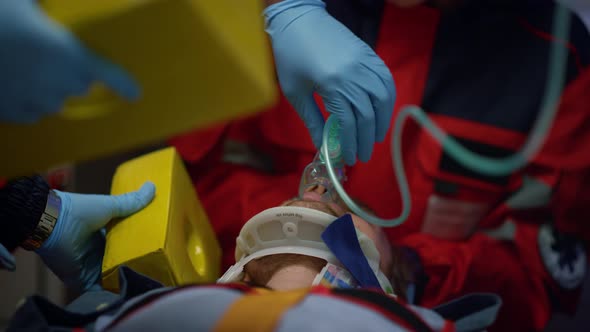 Paramedics Providing First Aid for Man alt