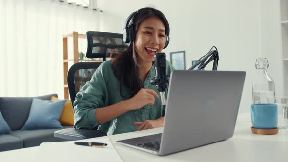 asia girl record a podcast with headphones and microphone look at camera  talk and take a rest.