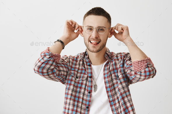 Guy with elf ears thinks they add charm to appearance. Portrait of good-looking funny man in