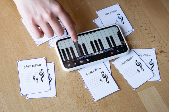 Close-up of cards for studying music and piano in the phone.