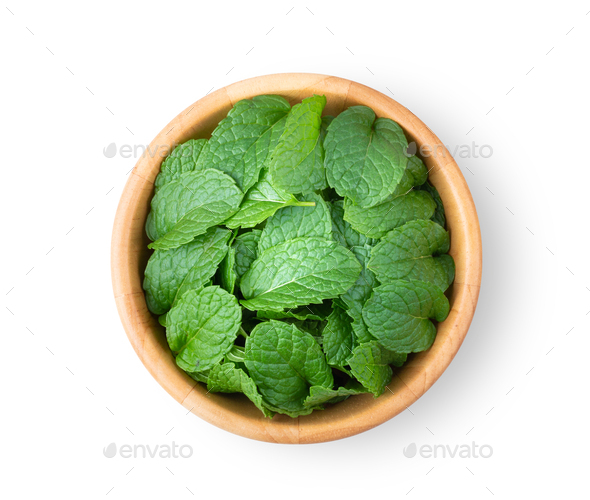 Fresh mint leaves pattern in wood bowl isolated on white background