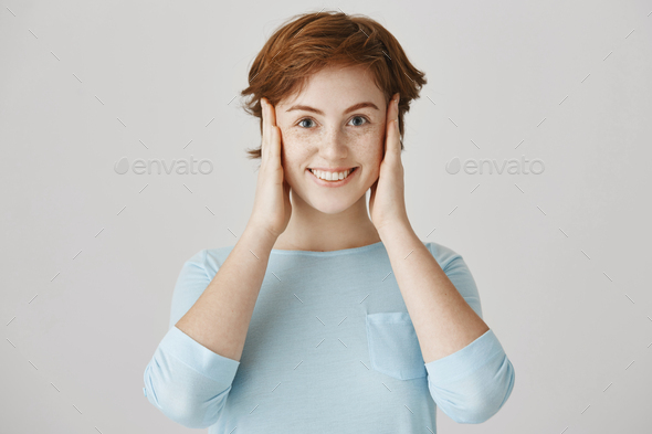 I am not listening, honestly. Portrait of positive attractive young european woman with red hair and