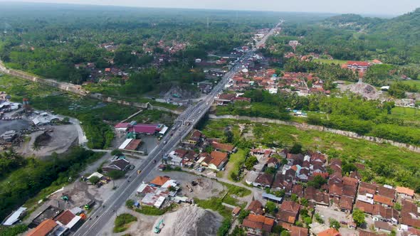 Traffic on highway through Kali Putih Bridge, infrastructure of Java, Indonesia alt