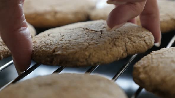 Picking by hand bread product from  baking rack 4K 2160p 30fps UltraHD footage - Female picks homema alt