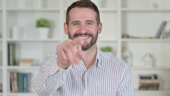 Portrait of Young Man Pointing Finger and Inviting alt