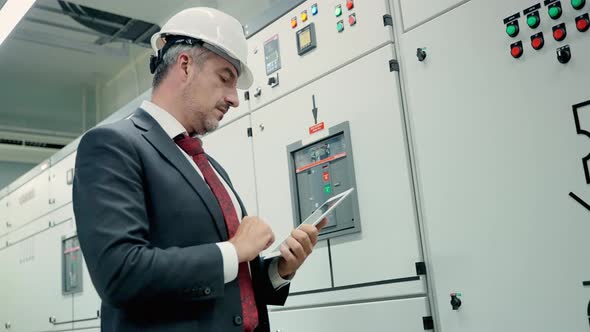 Electrical and Instrument technician checking electrical control board alt