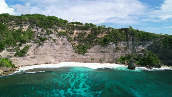 Aerial drone video of Diamond Beach in Nusa Penida Bali during the day alt