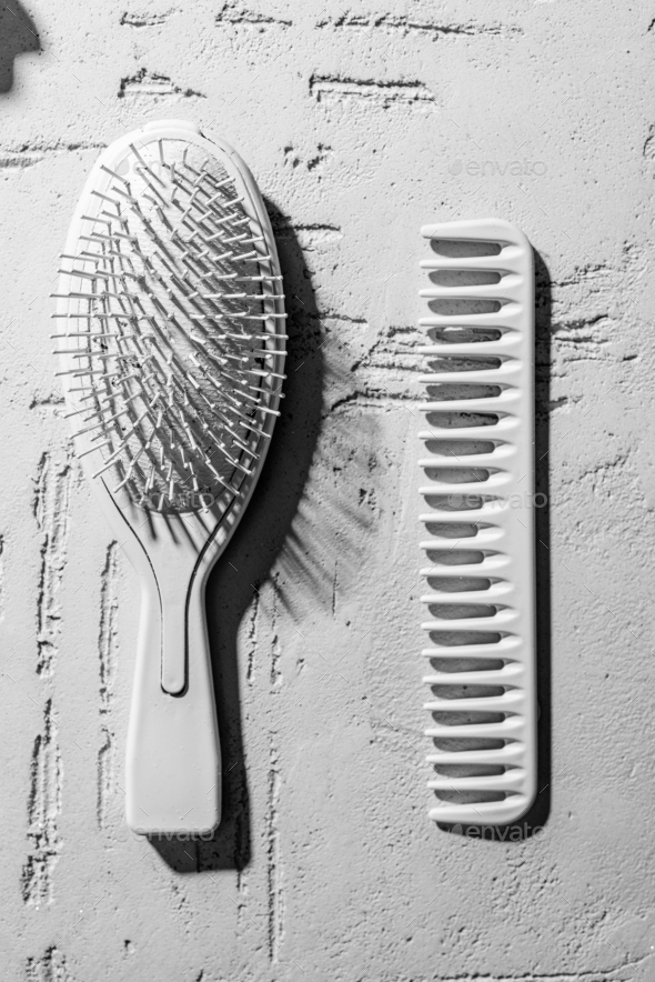 close-up view of decorative hair brush and comb on wall in beauty salon