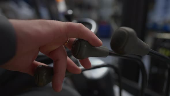 Closeup Male Hand Operating Loader Lever Indoors alt