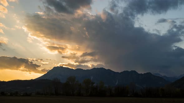 Rays of the Sun at Sunset From Behind the Mountain Timelapse