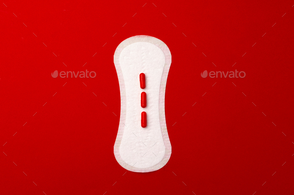Woman medical pad and painkiller pills