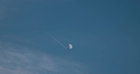 Plane Against Full Moon in the Blue Sky, Airplane Flying by the Moon