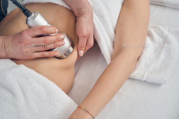 Reducing fat on the hips with ultrasound cavitation - Stock Photo - Images