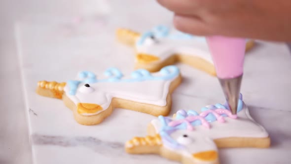 Step by step. Decorating unicorn shaped sugar cookies with royal icing for little girl birthday part alt