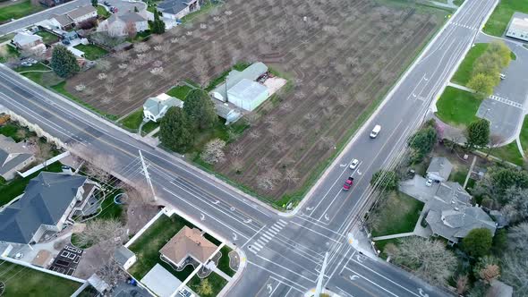 Flying over intersection as vehicles pull up to stop sign alt