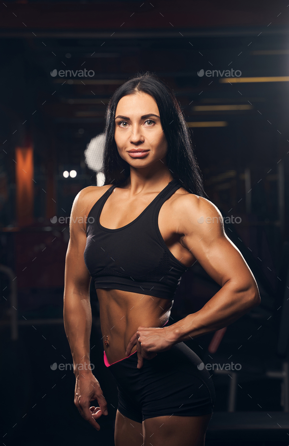 Female bodybuilder showing her strength by flexing her muscles
