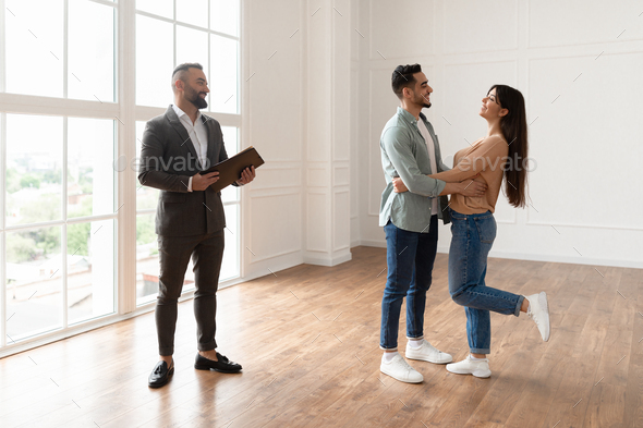 Excited Couple Buying New Apartment, Celebrating Successful Deal