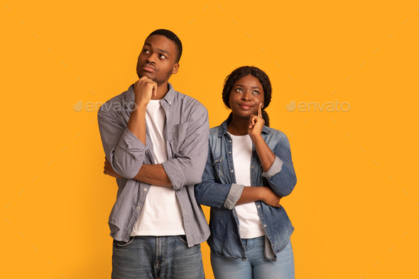 Let Me Think. Portrait Of Pensive Black Couple Isolated On Yellow Background