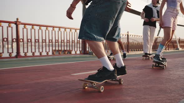 Four Teenagers Demonstrate Complex Tricks on Skateboards alt