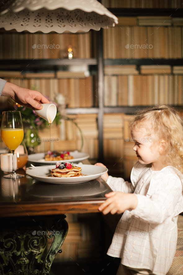 Family mother father and child have Breakfast in the cafe. Nutrition Concept. - Stock Photo - Images
