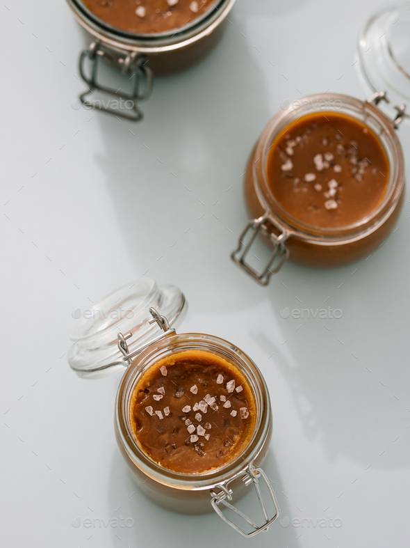 Salted caramel in glass jars, top view. Vertical - Stock Photo - Images