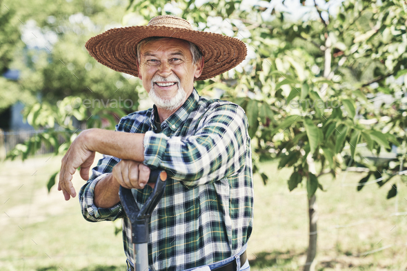 Portrait of happy farmer in a straw hat Stock Photo by gpointstudio