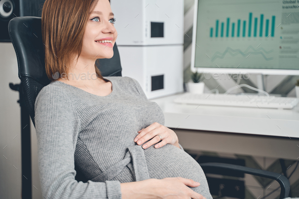 Beautiful smiling pregnant woman in black suit talking by phone Stock Photo  by ©Kryzhov 158114272