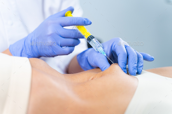Woman receiving a belly injection for figure correction