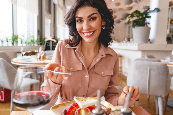 Beautiful young lady having lunch in cafe - Stock Photo - Images