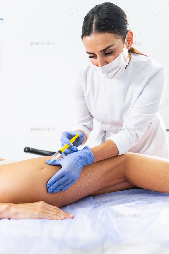 Female doctor performing a figure correction procedure