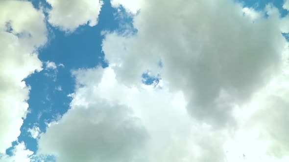 White clouds fly across a bright blue sky, Cloud time lapse