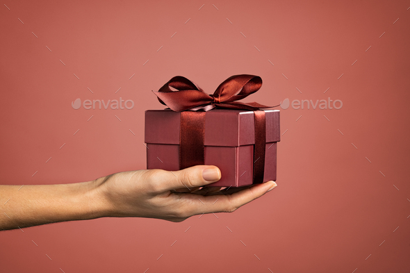 Woman hand holding elegant gift box - Stock Photo - Images