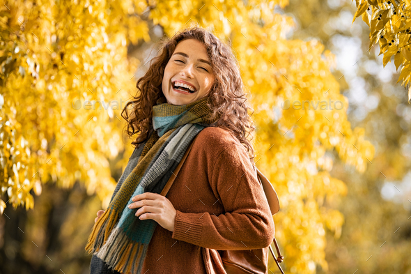Happy girl laughing in autumn park - Stock Photo - Images