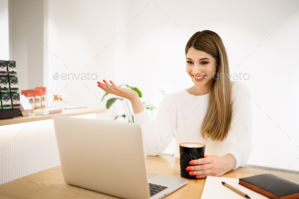 Happy sfemale blogger laughing while chatting with friends in social networks on laptop device - Stock Photo - Images