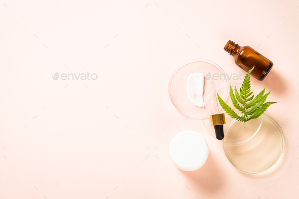 Glass petri dish with cosmetic products and green plants - Stock Photo - Images