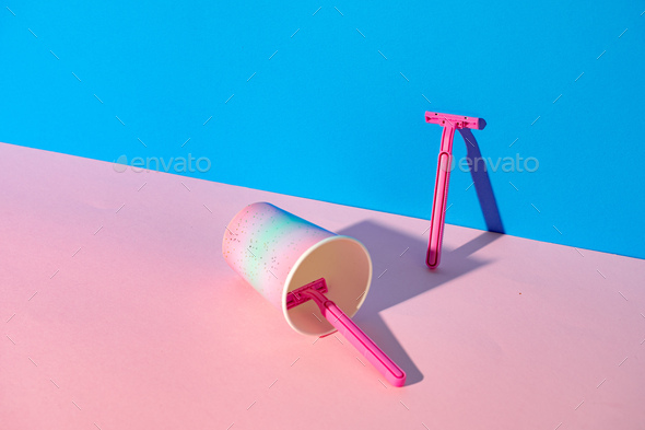 Female disposable razor in a cup, studio shot