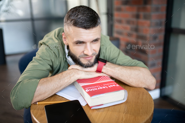 Bearded student feeling excited before passing language exam