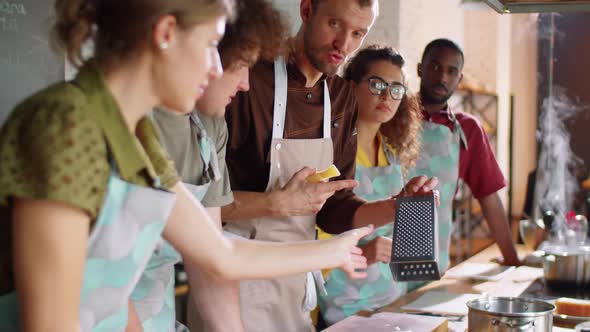 Chef Showing How to Grate Cheese at Cooking Master Class alt