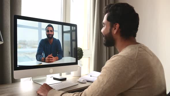 Indian Darkhaired Man Using Computer for Video Call