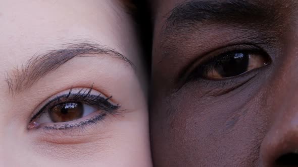  black man and white woman's eyes opening.Interracial race love concept-macro alt
