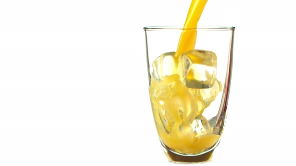 Super Slow Motion Shot of Pouring Fresh Orange Juice Into Glass with Ice Cubes at 1000 Fps alt